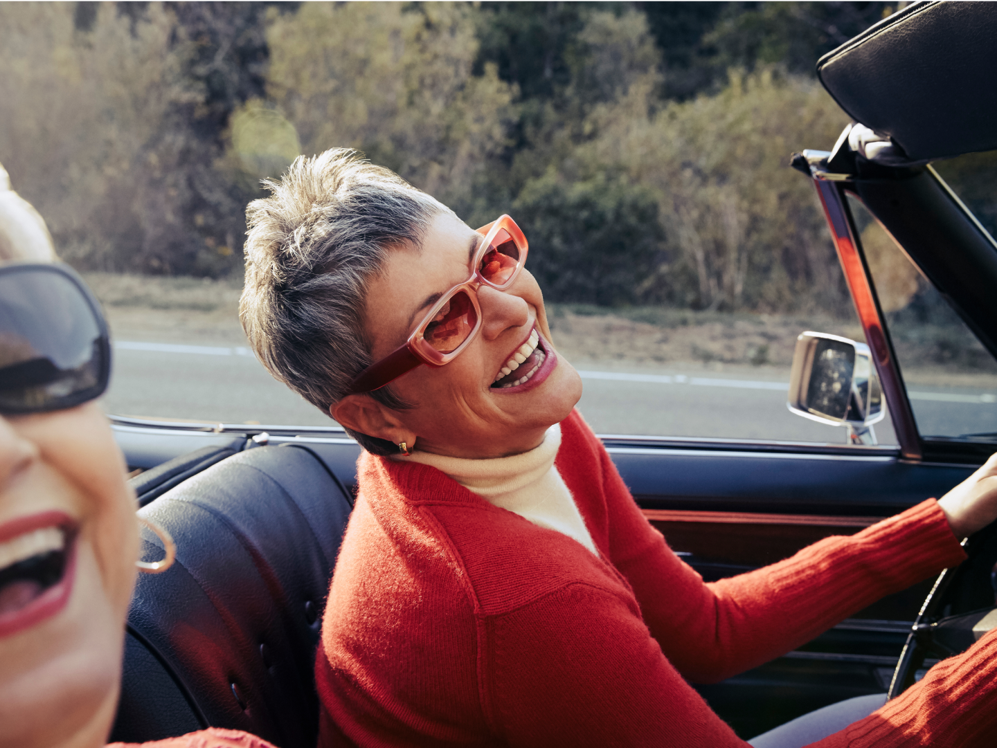 Outdoors - Two women laughing in a car